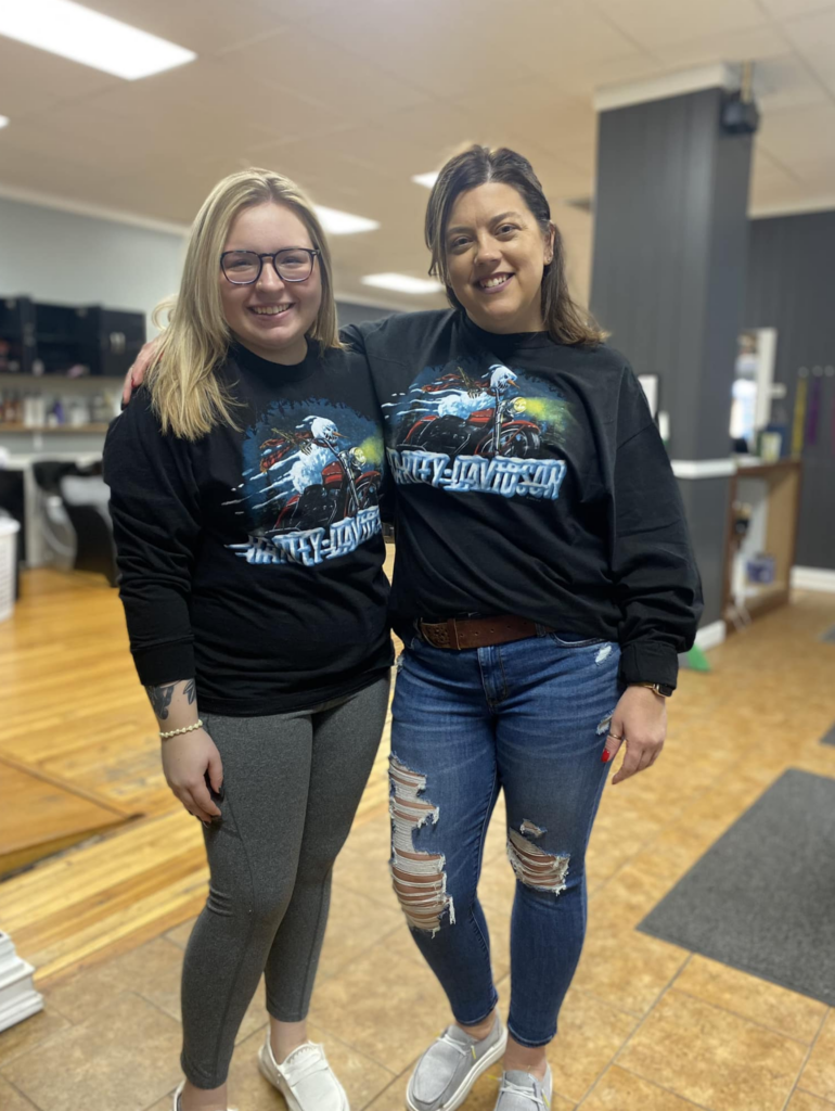 Lisa and employee with matching Harley Davidson tees